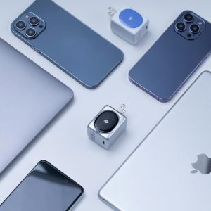 Flat lay of various Apple products including iPhone, iPad, MacBook, showcasing modern technology.